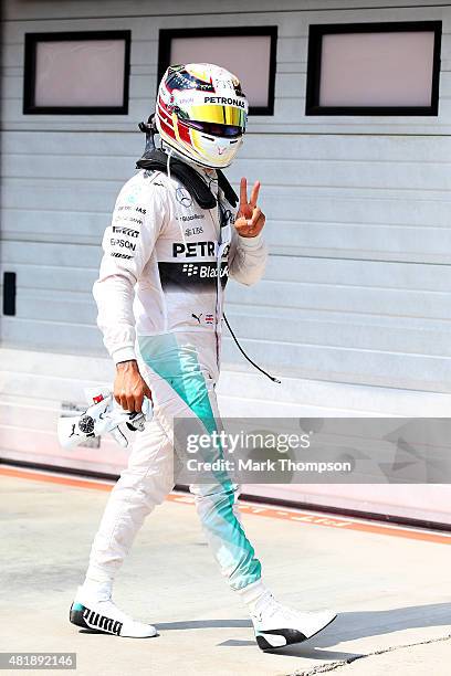 Lewis Hamilton of Great Britain and Mercedes GP celebrates in Parc Ferme after claiming pole position during qualifying for the Formula One Grand...