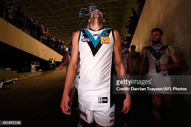 Paddy Ryder of the Power is showered in gatorade as he walks from the ground after the round 17 AFL match between the Essendon Bombers and the Port...