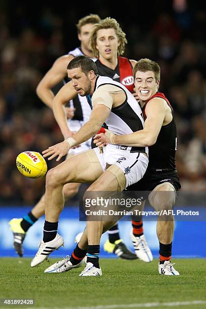 Zach Merrett of the Bombers tackles Travis Boak of the Power during the round 17 AFL match between the Essendon Bombers and the Port Adelaide Power...