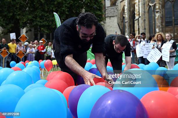 Activists burst balloons depicting the United Kingdom to highlight the perceived lack of fairness in the voting system during a Youth Parliament...