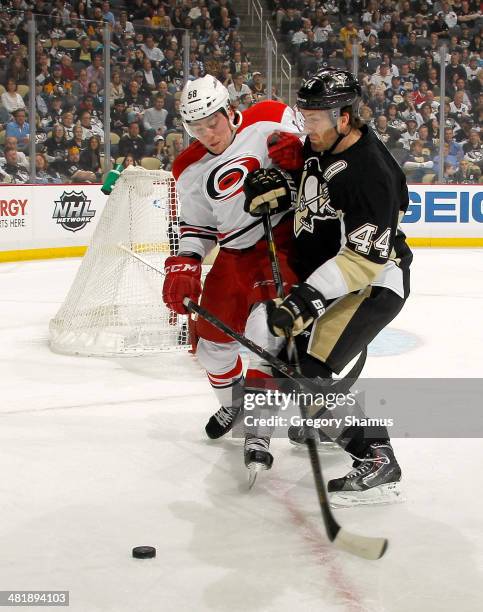 Chris Terry of the Carolina Hurricanes battles for the puck against Brooks Orpik of the Pittsburgh Penguins on April 1, 2014 at Consol Energy Center...