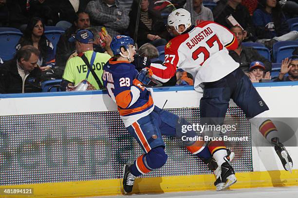 Nick Bjugstad of the Florida Panthers hits Johan Sundstrom of the New York Islanders during the first period at the Nassau Veterans Memorial Coliseum...