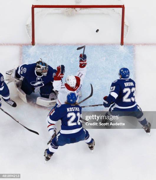 Brendan Gallagher of the Montreal Canadiens celebrates his goal against goalie Ben Bishop, Mike Kostka, and J.T. Brown of the Tampa Bay Lightning...