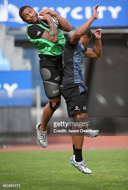 Manu Vatuvei and Glen Fisiiahi of the Warriors compete for the high ball during a New Zealand Warriors NRL training session at Mt Smart Stadium on...