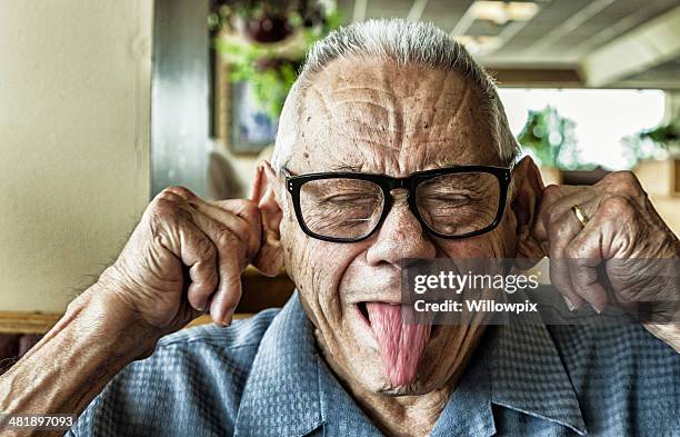 funny elderly man goofy mug shot - pulling ear stock pictures, royalty-free photos & images