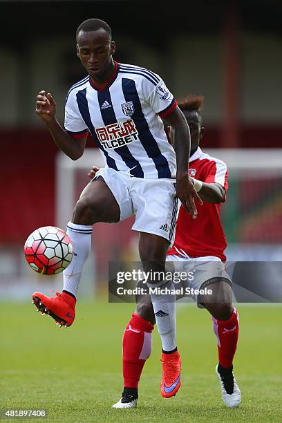 Saido Berahino of West Bromwich Albion lays the ball off as Drissa Traore of Swindon Town closes in during the Pre-Season Friendly match between...