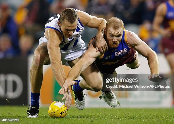 Drew Petrie of the Kangaroos and Daniel Merrett of the Lions in action during the 2015 AFL round 17 match between the Brisbane Lions and the North...