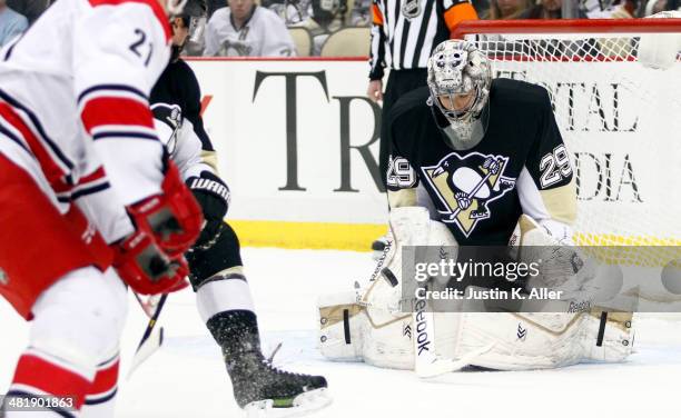 Marc-Andre Fleury of the Pittsburgh Penguins makes a save on Drayson Bowman of the Carolina Hurricanes during the game at Consol Energy Center on...