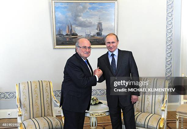 Russian President Vladimir Putin poses with FIFA President Joseph Blatter prior to the Preliminary Draw FIFA World Cup 2018 at the Konstantinovsky...