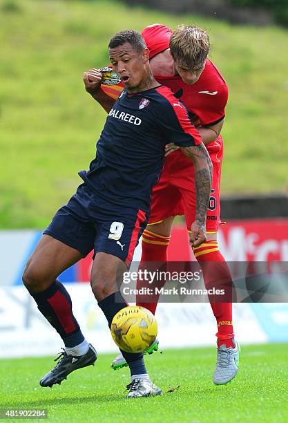 Liam Lindsay of Patrick Thistle challenges with Jonson Clarke-Harris of Rotherham during a pre season friendly match between Patrick Thistle FC and...