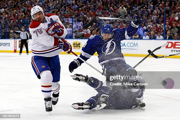 Andrei Markov of the Montreal Canadiens and Tyler Johnson of the Tampa Bay Lightning collide at the Tampa Bay Times Forum on April 1, 2014 in Tampa,...