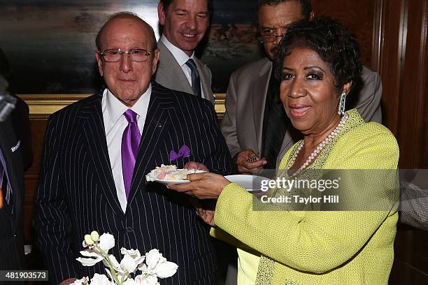 Aretha Franklin serves Clive Davis cake at Aretha Franklin's 72nd Birthday Celebration on March 22, 2014 in New York City.