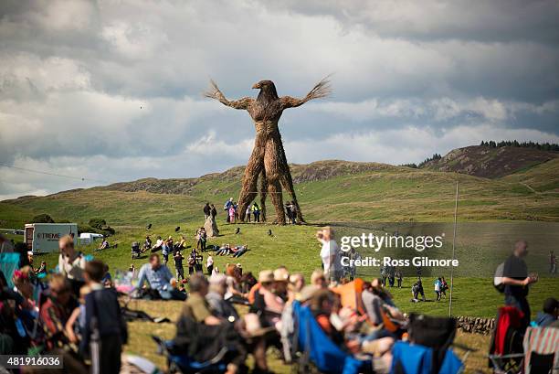 Festival goers enjoy the atmosphere as clouds loom overhead during the Wickerman festival at Dundrennan on July 25, 2015 in Dumfries, Scotland.