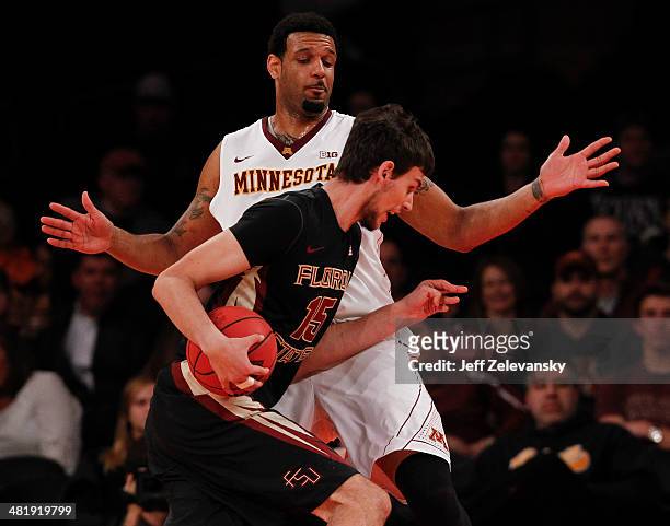 Andre Hollins of the Minnesota Golden Gophers guards Boris Bojanovsky of the Florida State Seminoles during the NIT Championship semifinals at...