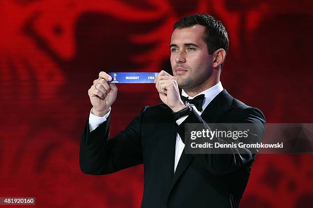 Draw assistant Alexander Kerzhakov holds up the name Norway during the European Zone draw at the Preliminary Draw of the 2018 FIFA World Cup in...