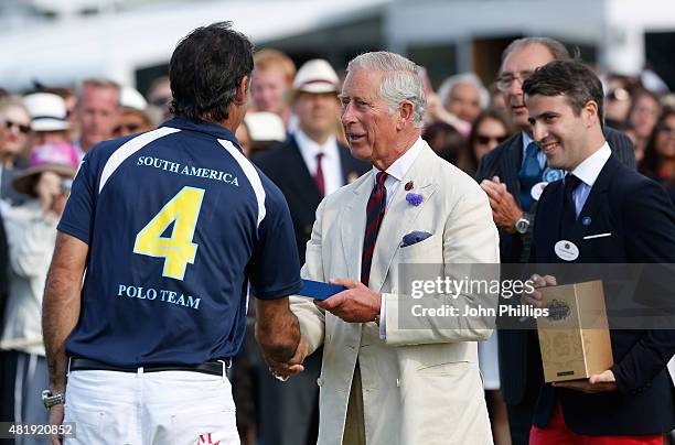 Jaime Garcia Huidobro receives an award from Prince Charles, Prince of Wales and Jacques-Henri Brive at The Royal Salute Coronation Cup at Guards...