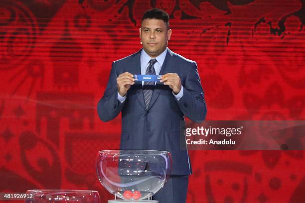 Former Brazilian striker Ronaldo shows the name of Bolivia during the preliminary draw for the South American Football Confederation zone for the...