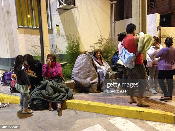 Locals gather on the street following a tsunami alert after a powerful 8.0-magnitude earthquake struck off Chile's Pacific coast on April 1, 2014 in...