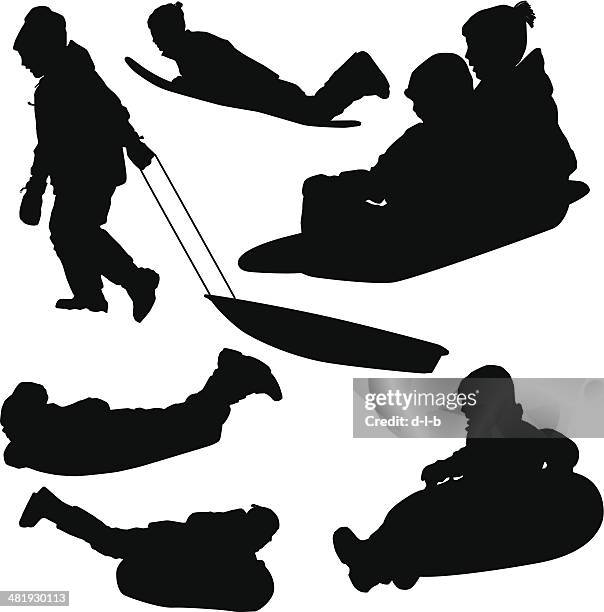 silhouettes of kids sledding - tobogganing stock illustrations