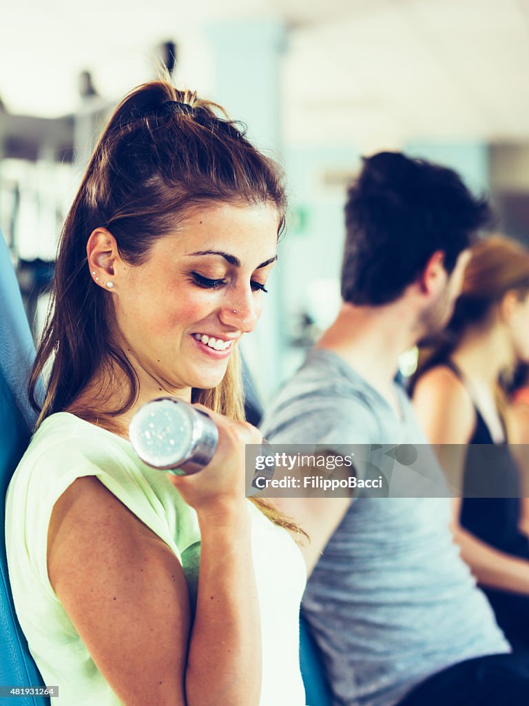 Jeune femme exerçant dans la salle de sport