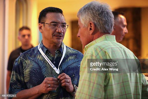 Secretary of Defense Chuck Hagel listens to Malaysian Defence Minister and acting transport minister Hishammuddin Hussein during a welcome reception...