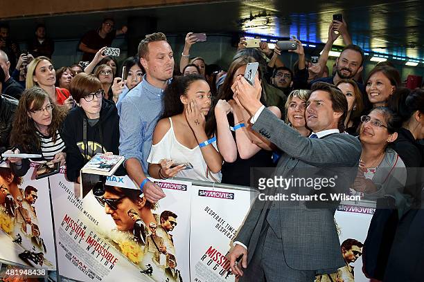 Tom Cruise with fans as he attends the UK Fan Screening of 'Mission: Impossible - Rogue Nation' at the IMAX Waterloo on July 25, 2015 in London,...