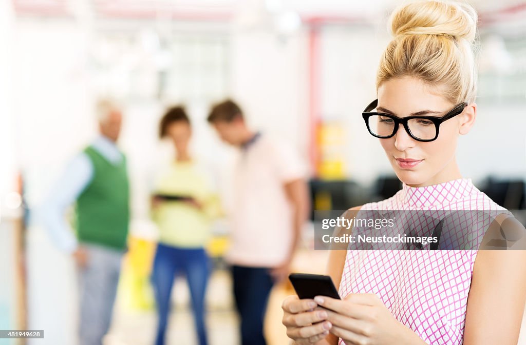 Businesswoman In Nerd Glasses Using Smart Phone