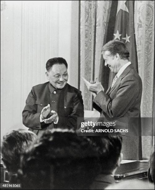 Chinese Vice-Premier Deng Xiaoping shown in a a photo dated 31 January 1979 applauding with US President Jimmy Carter after signing three agreements...