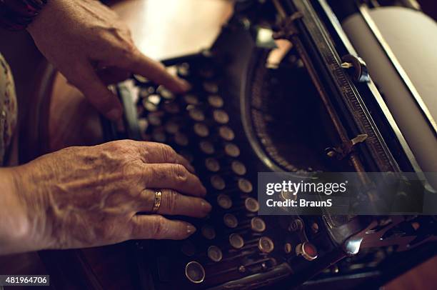 unrecognizable senior person typing on typewriter. - female authors stock pictures, royalty-free photos & images