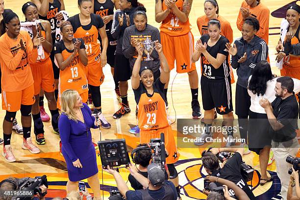 Maya Moore of the Western Conference All Stars holds up the MVP trophy after the Boost Mobile WNBA All-Star 2015 Game at the Mohegan Sun Arena on...