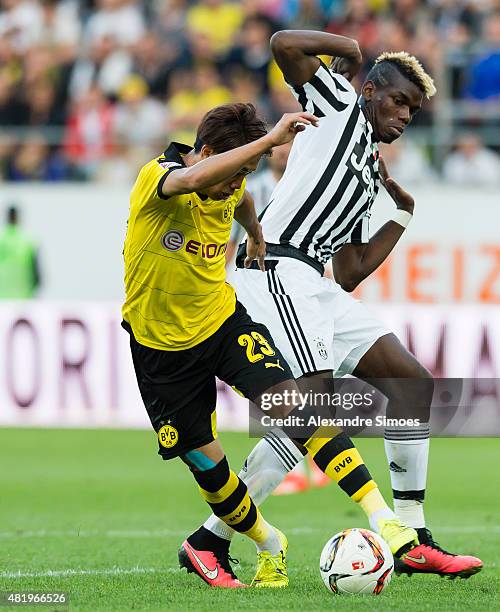 Paul Dogba of Juventus Turin challenges Shinji Kagawa of Borussia Dortmund during the preseason friendly match between Borussia Dortmund v Juventus...