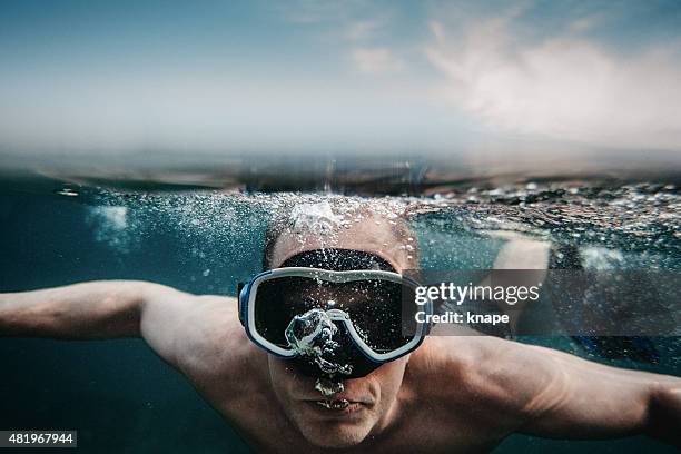 man scuba diving underwater in sea with mask - scuba mask stock pictures, royalty-free photos & images