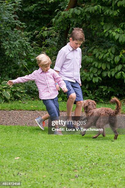 Prince Vincent of Denmark Prince Christian of Denmark play with their dog during the annual summer Photocall for The Danish Royal Family at Grasten...