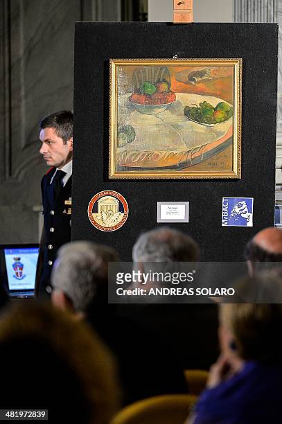 Carabinieri stand next to the painting by French artists Paul Gauguin "Fruits sur une table ou nature morte au petit chien", one of the two paintings...