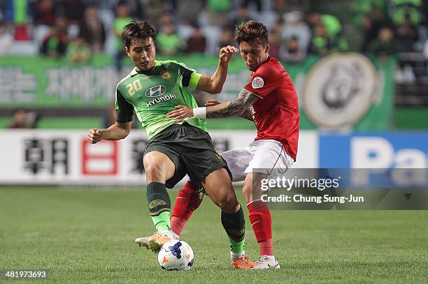 Zhang Linpeng of Guangzhou Evergrande compete for the ball with Lee Dong-Gook of Jeonbuk Hyundai Motors during the AFC Champions League Group G match...