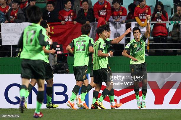 Leonardo of Jeonbuk Hyundai Motors celebrates with team mates after scoring his team's first goal during the AFC Champions League match between...