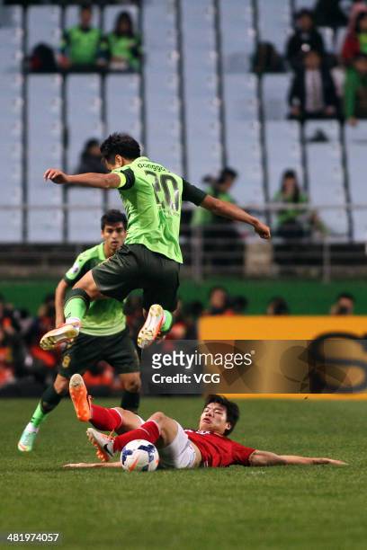 Mei Fang of Guangzhou Evergrande and Lee Dong-Gook of Jeonbuk Hyundai Motors battle for the ball during the AFC Champions League match between...