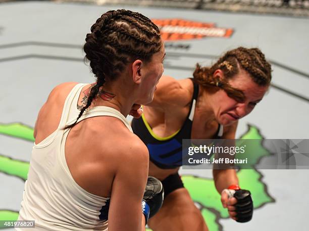 Miesha Tate drops Jessica Eye with a punch in their women's bantamweight bout during the UFC event at the United Center on July 25, 2015 in Chicago,...