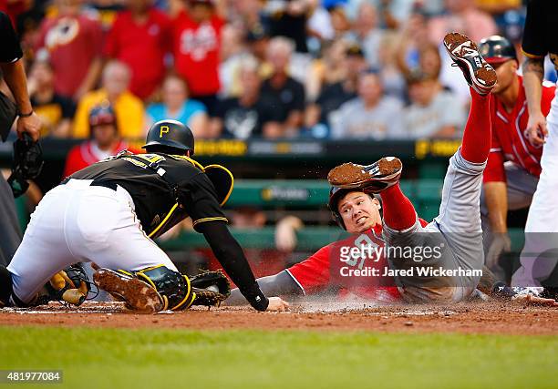 Francisco Cervelli of the Pittsburgh Pirates tags out Jose Lobaton of the Washington Nationals after his attempt on a pop fly in the fourth inning...