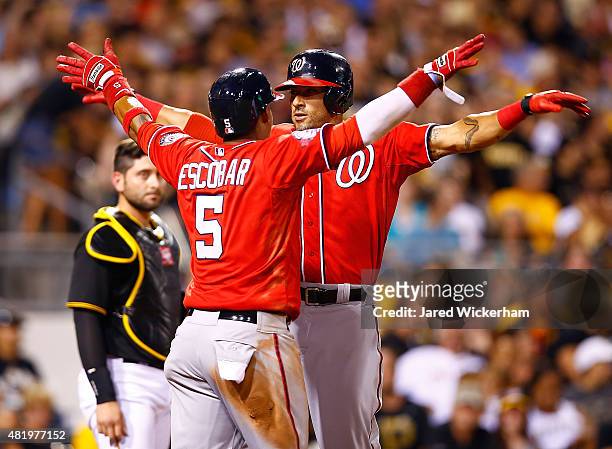 Ian Desmond of the Washington Nationals celebrates with teammate Yunel Escobar after hitting a two run home run in the seventh inning against the...