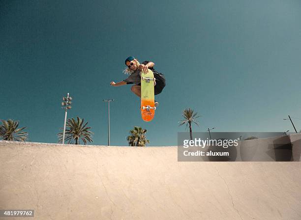 young man jumping with skateboard - skating stock pictures, royalty-free photos & images