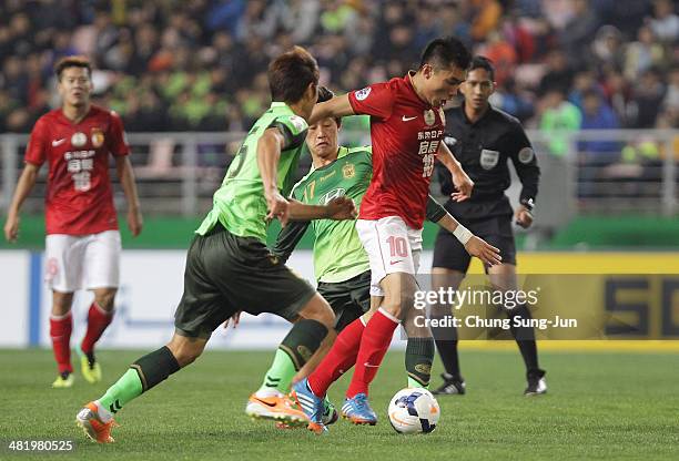 Zheng Zhi of Guangzhou Evergrande compete for the ball with Lee Jae-Sung of Jeonbuk Hyundai Motors during the AFC Champions League Group G match...