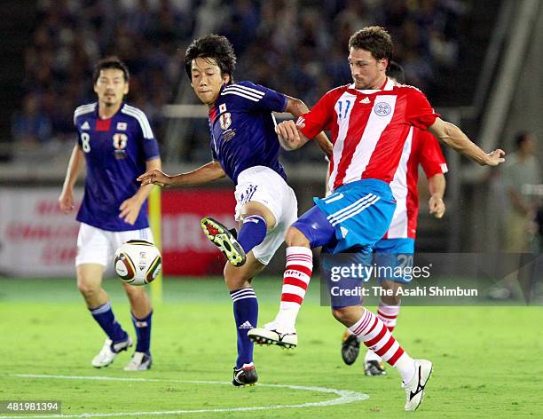 Kengo Nakamura of Japan and Jonathan Santana of Paraguay compete for the ball during the international friendly match between Japan and Paraguay at...
