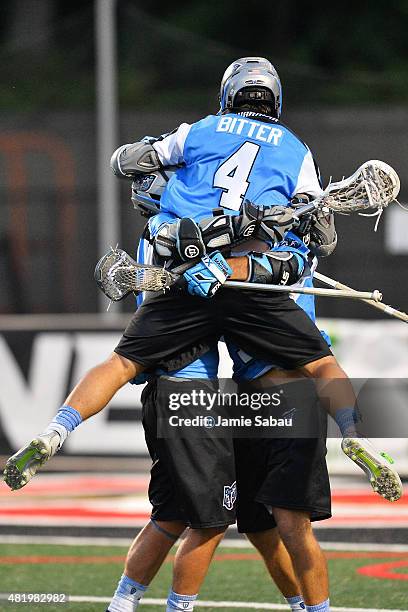 Jimmy Bitter of the Ohio Machine jumps on teammates Steele Stanwick and Marcus Holman to celebrate a Stanwick goal in the fourth quarter against the...