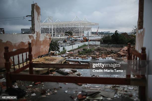 Bedframe remains in a partially demolished home in the Vila Autodromo 'favela' community, with the Olympic Aquatics Stadium construction ongoing in...