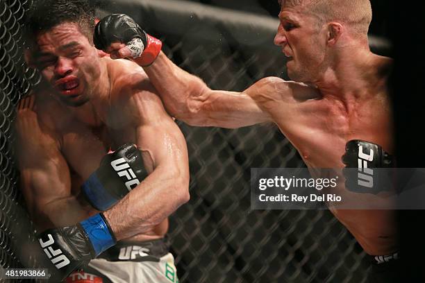 Dillashaw punches Renan Barao in their UFC bantamweight championship bout during the UFC event at the United Center on July 25, 2015 in Chicago,...