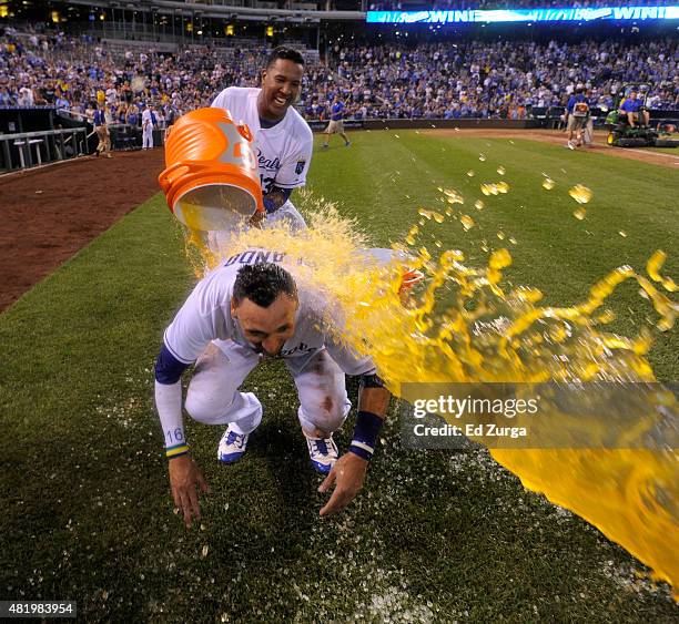 Paulo Orlando of the Kansas City Royals is doused with Gatorade by Salvador Perez as they celebrate a 2-1 win over the Houston Astros in 10 innings...