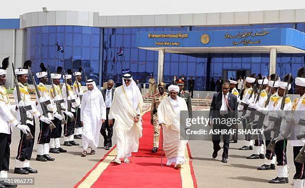 President of Sudan Omar al-Bashir walks with Emir of Qatar, Sheikh Tamim bin Hamad Al-Thani ahead of the latter's departure at Khartoum airport on...