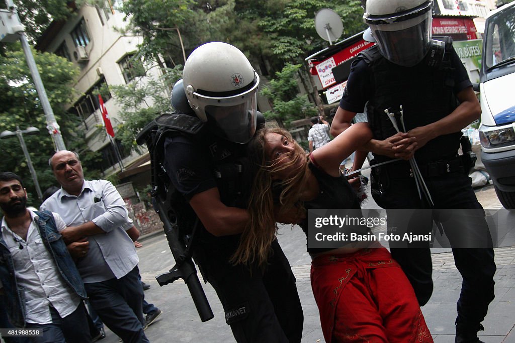 A women is detained by Turkish police during a protest...
