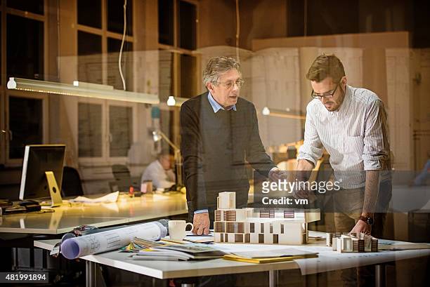 two architects discussing new project - architectural model stockfoto's en -beelden